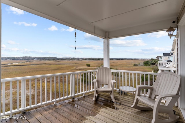 wooden terrace featuring a rural view