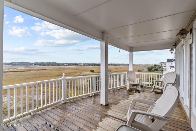 wooden terrace featuring a rural view