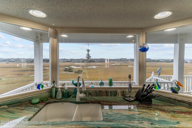 sunroom featuring sink and a rural view