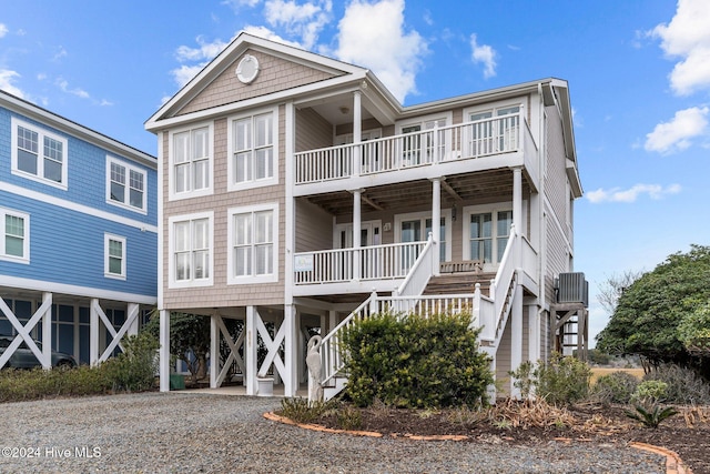 coastal inspired home featuring covered porch