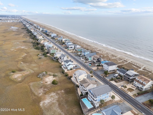 birds eye view of property featuring a water view and a beach view