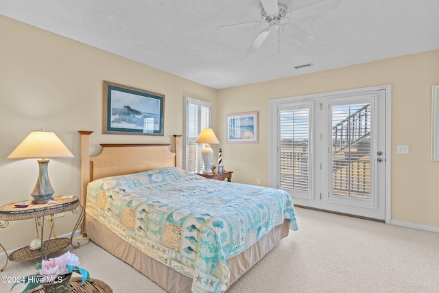 bedroom with a textured ceiling, access to outside, ceiling fan, and light colored carpet