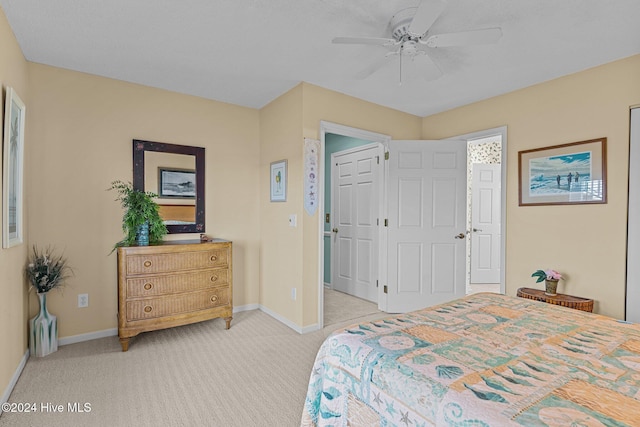 bedroom featuring light colored carpet and ceiling fan