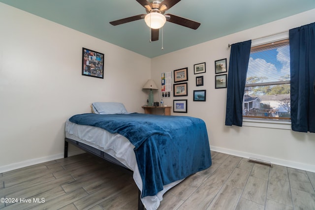 bedroom featuring ceiling fan and hardwood / wood-style flooring