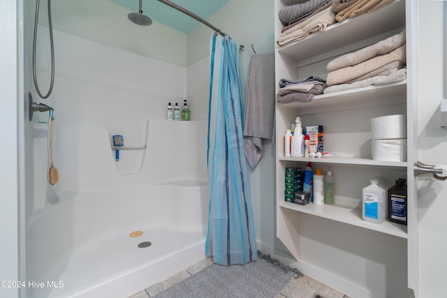 bathroom with tile patterned floors and a shower with shower curtain