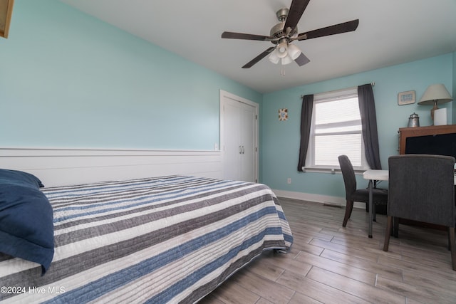 bedroom with ceiling fan and light wood-type flooring