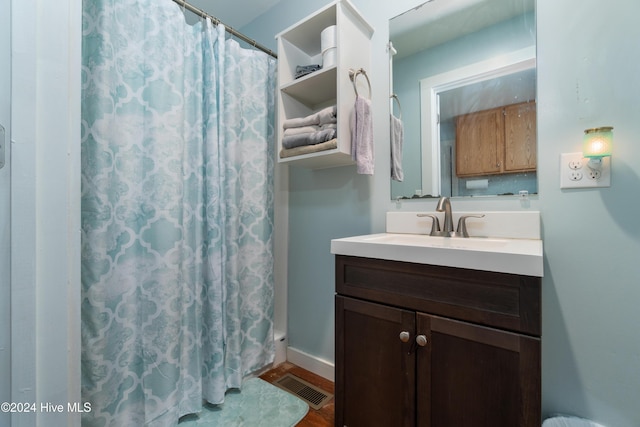 bathroom featuring a shower with curtain, hardwood / wood-style floors, and vanity