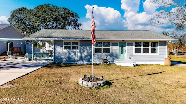 view of front of property featuring a front yard and a carport