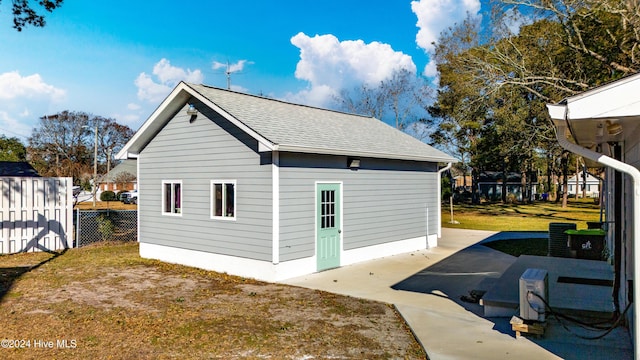 rear view of property featuring a yard and a patio