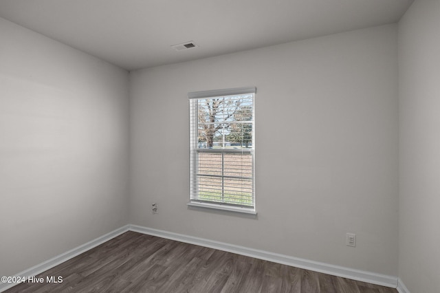 spare room featuring dark hardwood / wood-style flooring