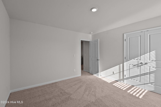 unfurnished room with light colored carpet