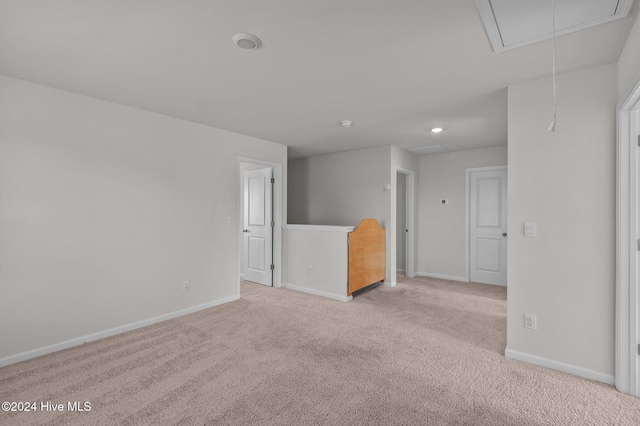 unfurnished room featuring light colored carpet