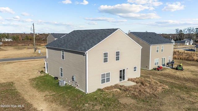 view of home's exterior with central air condition unit and a yard