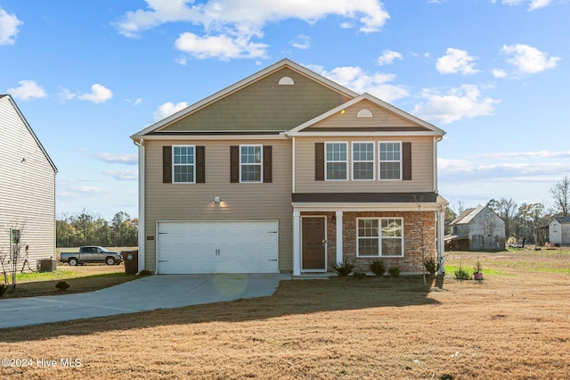 view of front property with a garage, a front yard, and central air condition unit