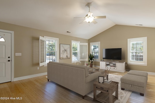 living room with ceiling fan, light hardwood / wood-style floors, and lofted ceiling