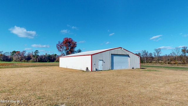 view of outdoor structure featuring a lawn and a garage