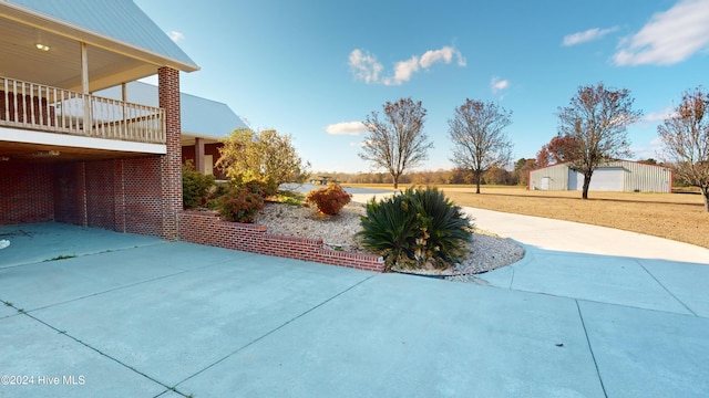 view of patio / terrace featuring a garage and an outdoor structure