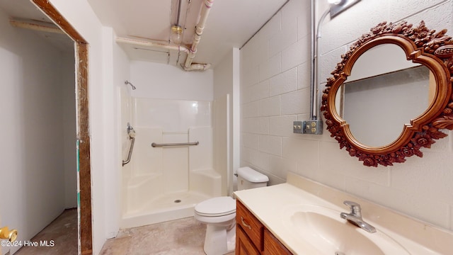 bathroom featuring a shower, vanity, and toilet