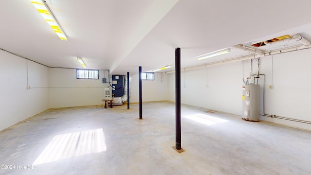 basement featuring heating unit and water heater