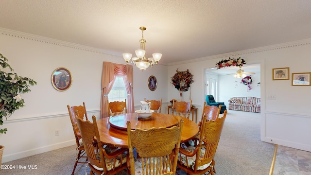 carpeted dining area with ceiling fan with notable chandelier, ornamental molding, and a textured ceiling