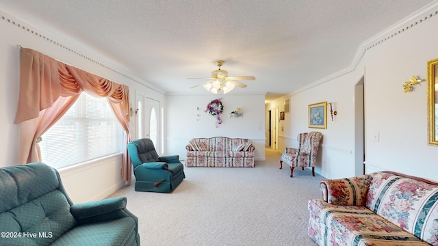 living room with carpet, ceiling fan, ornamental molding, and a textured ceiling