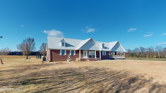 view of front of property featuring a porch and a storage unit