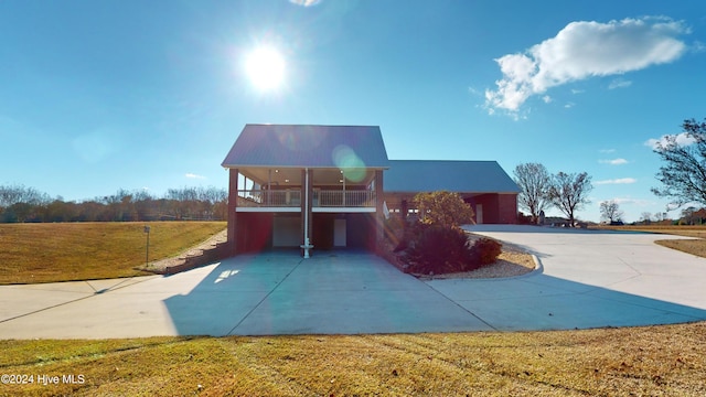 view of front facade featuring a garage, a balcony, and a front lawn