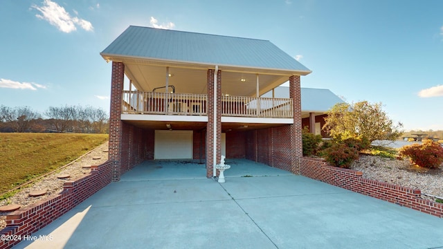 back of property featuring a carport and a garage