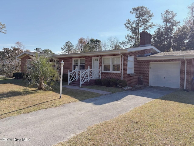 view of front of home with a front lawn and a garage