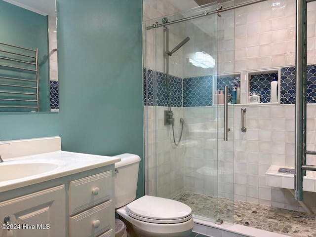 bathroom featuring vanity, toilet, and an enclosed shower