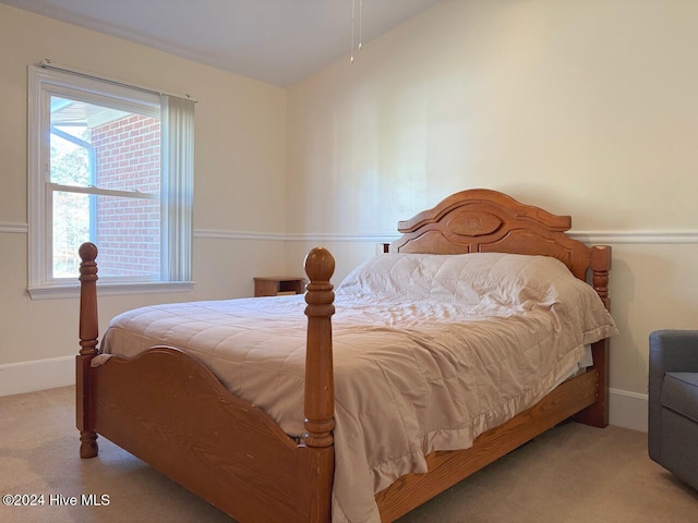 carpeted bedroom with multiple windows and lofted ceiling