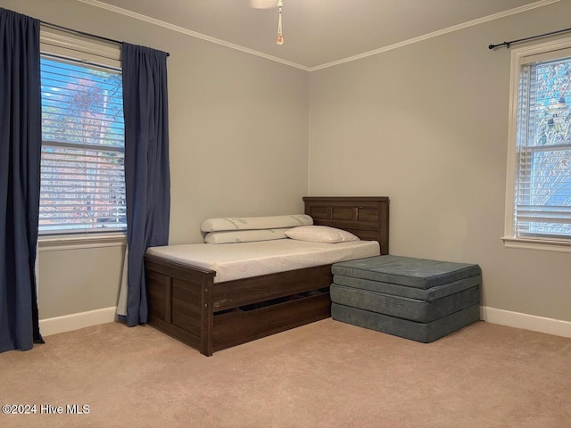 bedroom with light carpet, multiple windows, and crown molding