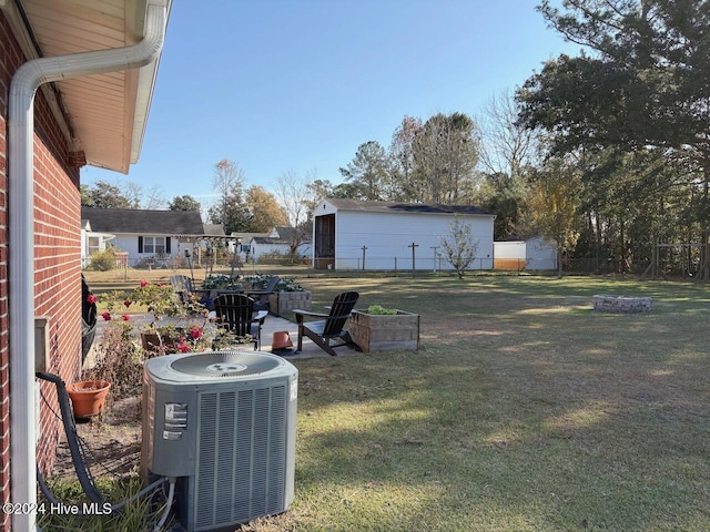 view of yard featuring a fire pit and central air condition unit