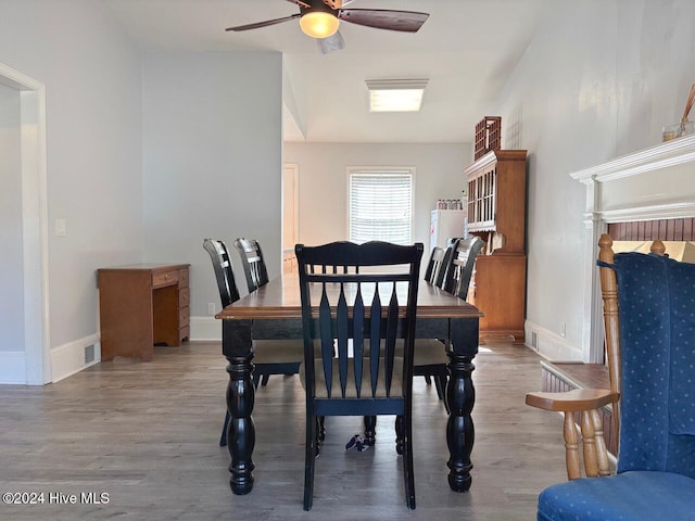 dining space with ceiling fan and hardwood / wood-style floors