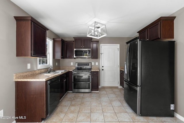 kitchen featuring dark brown cabinetry, stainless steel appliances, sink, decorative light fixtures, and light tile patterned flooring