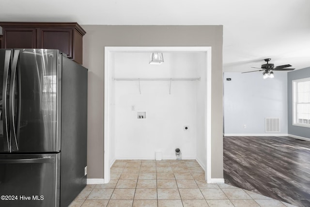 kitchen featuring ceiling fan, dark brown cabinetry, stainless steel refrigerator, and light hardwood / wood-style flooring