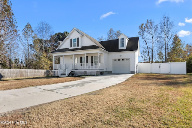 view of front of house with a front yard, a porch, and a garage