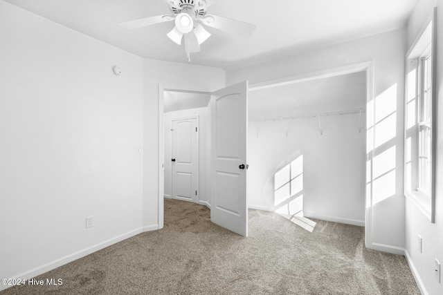 empty room with ceiling fan and carpet floors