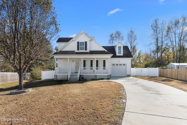 view of front of home featuring a porch, a garage, and a front lawn