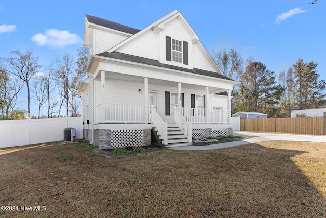 view of front of property featuring a porch, a front lawn, and central air condition unit