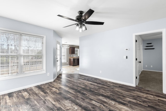 spare room featuring ceiling fan and dark wood-type flooring