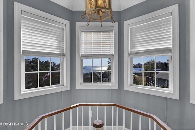 stairs featuring an inviting chandelier