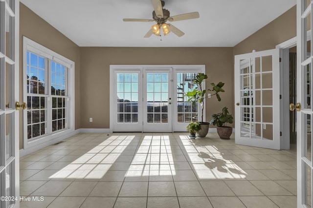 doorway to outside with ceiling fan, french doors, and light tile patterned floors