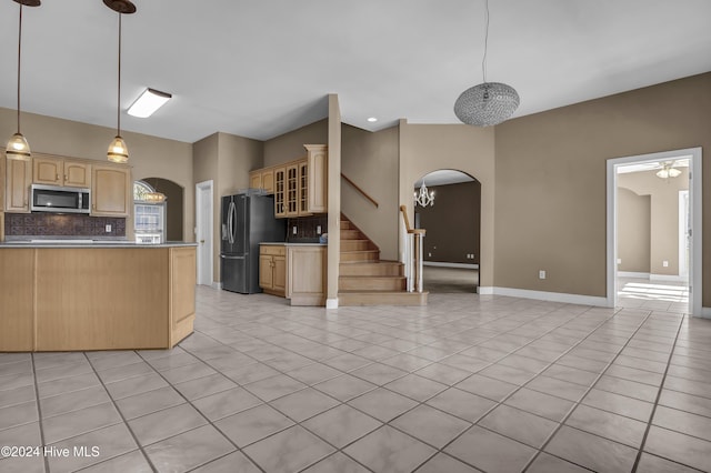 kitchen with backsplash, stainless steel appliances, ceiling fan, light brown cabinets, and light tile patterned flooring