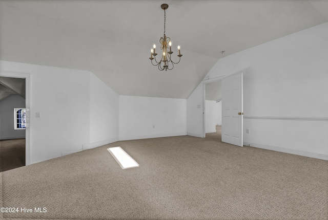 additional living space featuring carpet, lofted ceiling, and an inviting chandelier