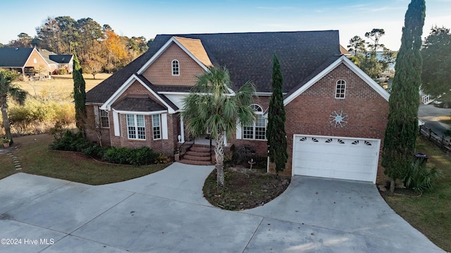 view of front of home featuring a garage and a front lawn