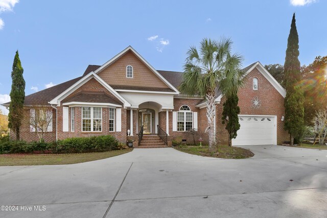 view of front facade with a garage and a water view