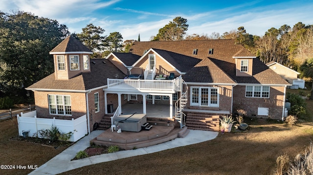 view of front of home with a hot tub, a front lawn, a patio area, and a wooden deck