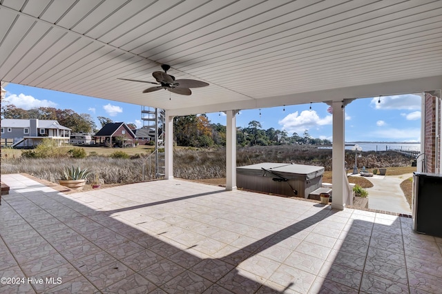 view of patio with ceiling fan and a hot tub