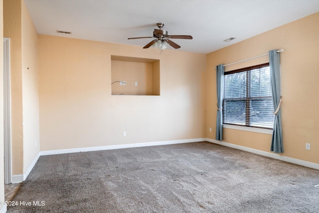 empty room featuring ceiling fan and carpet flooring